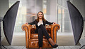 young woman sitting comfortably and confidently in an arm chair